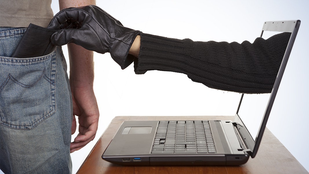 Man Getting Wallet Taken From Pocket Through Computer Screen