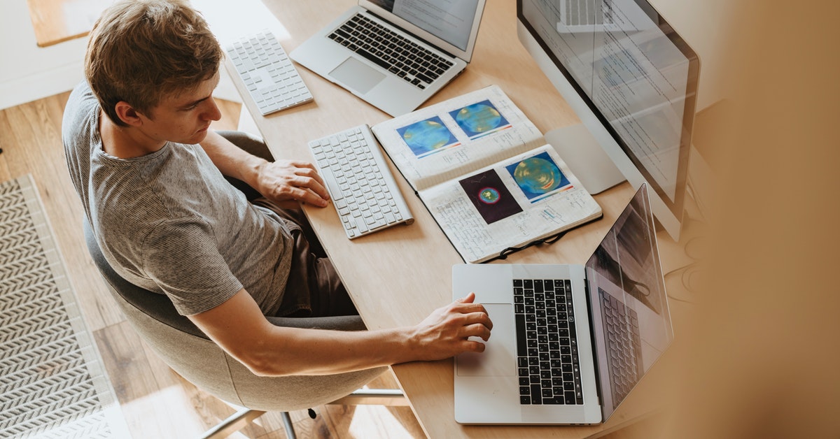 Man Using Three Computers