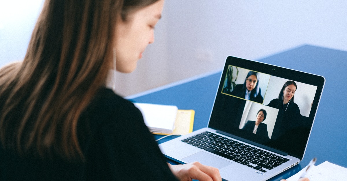 Woman looking at video call on laptop